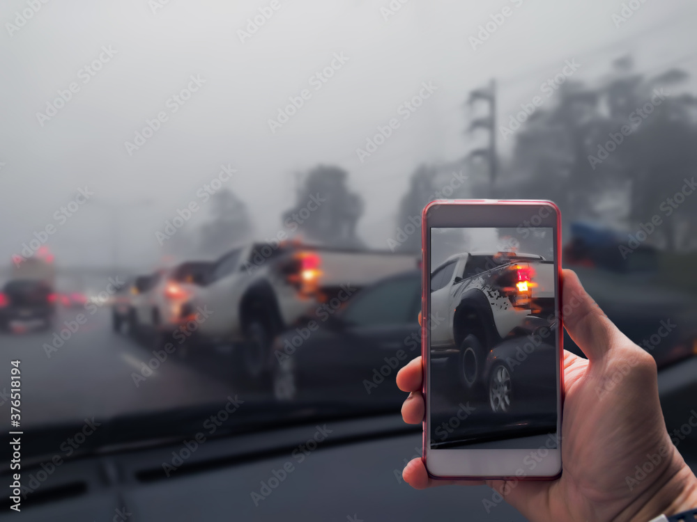 Close Up Of A Hand Taking Photo Of Car Accident Through Smartphone, Car crash from car accident on the road in a city car pickup wait insurance smartphone call a car insurance. Close Up Of A Hand Taking Photo Of Car Accident Through Smartphone, Car crash from car accident on the road in a city car pickup wait insurance smartphone call a car insurance.