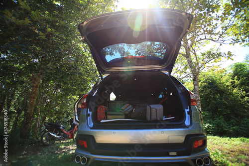 Fotografia Travel concept, SUV car with rear tail gaet open for load and unload camping art