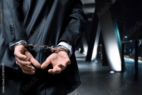 Criminal man with his hands in handcuffs
