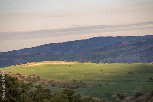 Aerial view of endless lush pastures and farmlands of Turkey. Rural landscape on sunset.