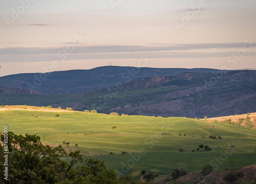 Aerial view of endless lush pastures and farmlands of Turkey. Rural landscape on sunset.