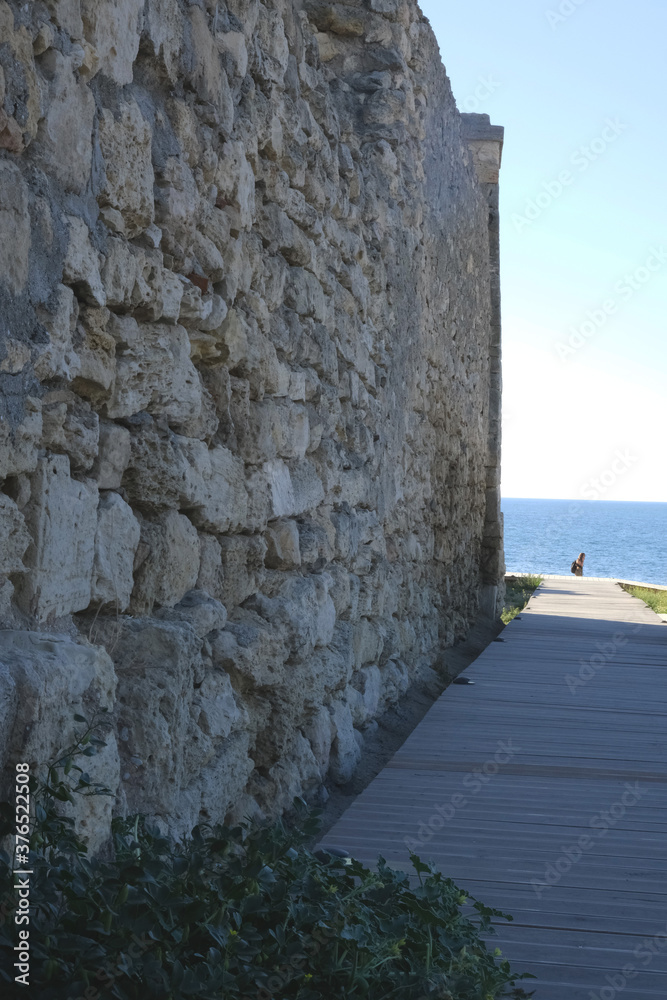 Stone wall texture. Old castle stone wall texture background. Stone wall as background or texture. Sea view.