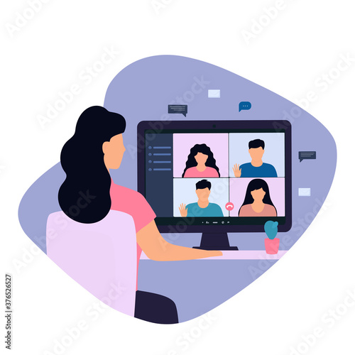 Woman having a video call with coworker, remote working online from home. The girl is sitting in a chair at his desk in front of a computer monitor.