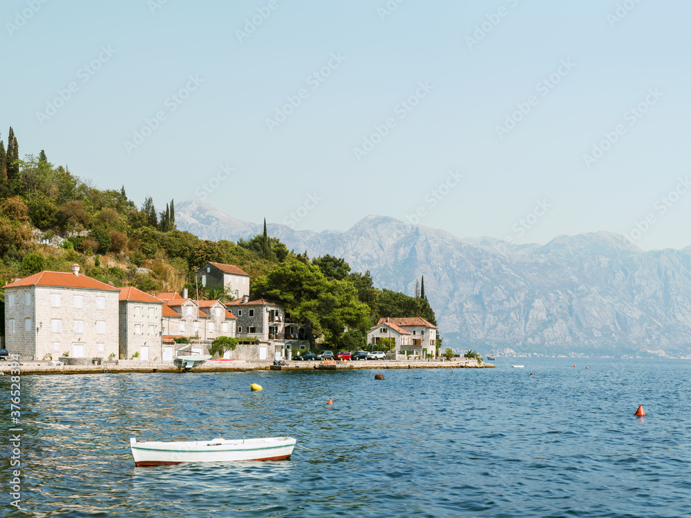 Fragment of the Bay of Kotor, Adriatic Sea, Montenegro. View of the embankment of the town of Perast and the Balkan Mountains.