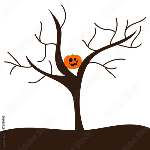 Scary pumpkin on a dry tree