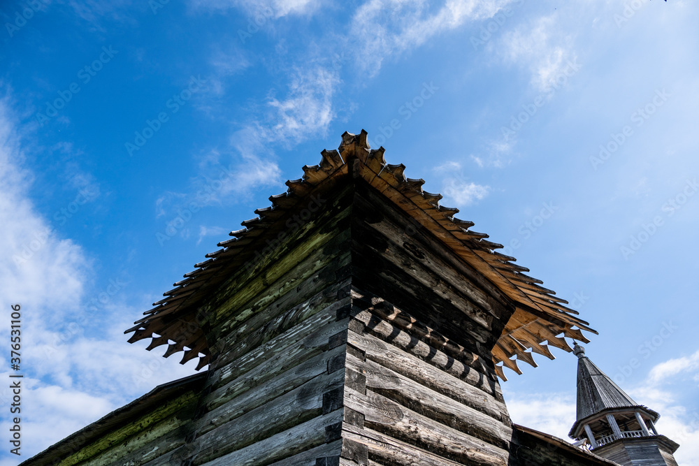vintage wooden complex with temple watchtower and fortress wall against blue sky