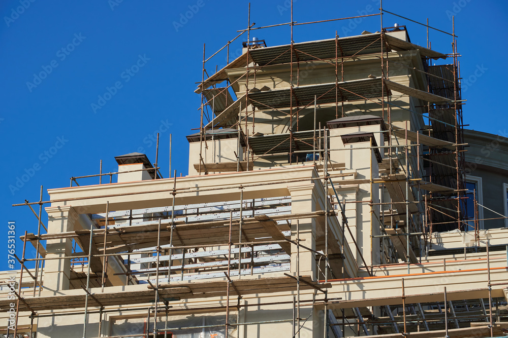 scaffolding and new building as background scaffolding and new building as background