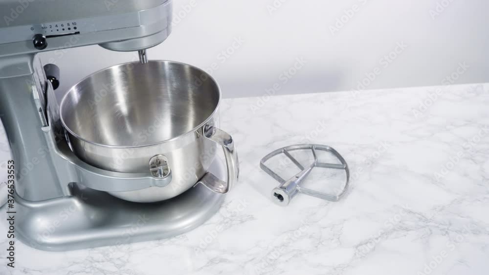 Step by step. Mixing ingredients in standing electric mixer for baking peanut butter cookies.