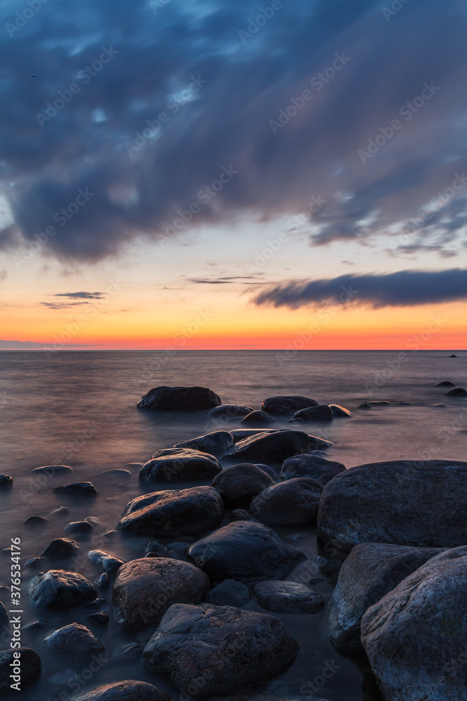 Rocky shore and peninsula of Baltic sea at sunset. Nordic minimalistic wilderness.