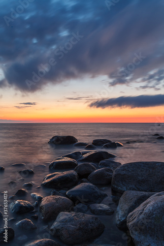 Rocky shore and peninsula of Baltic sea at sunset. Nordic minimalistic wilderness.
