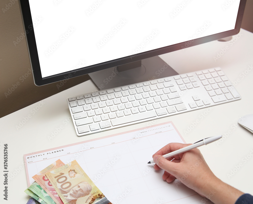 Winnipeg, Manitoba / Canada - August 22, 2020: Canadian Dollar on a Minimalist Workstation. Winnipeg, Manitoba / Canada - August 22, 2020: Canadian Dollar on a Minimalist Workstation.