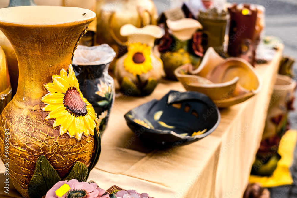 Fototapeta premium Happy colorful ceramics. Traditional Romanian handmade ceramics market at the potters fair from Sibiu, Romania