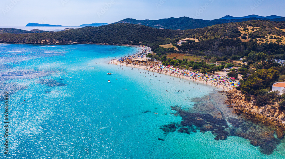 Obraz premium Aerial shot of Tuerredda beach on a beautiful day, Sardinia, Italy. Aerial drone view of Tuerredda in Sardegna. Famous Tuerredda beach on the south of Sardinia near Teulada. Sardinia, Italy.