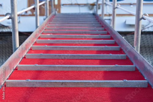 Ships gangway with a red velvet carpet. photo