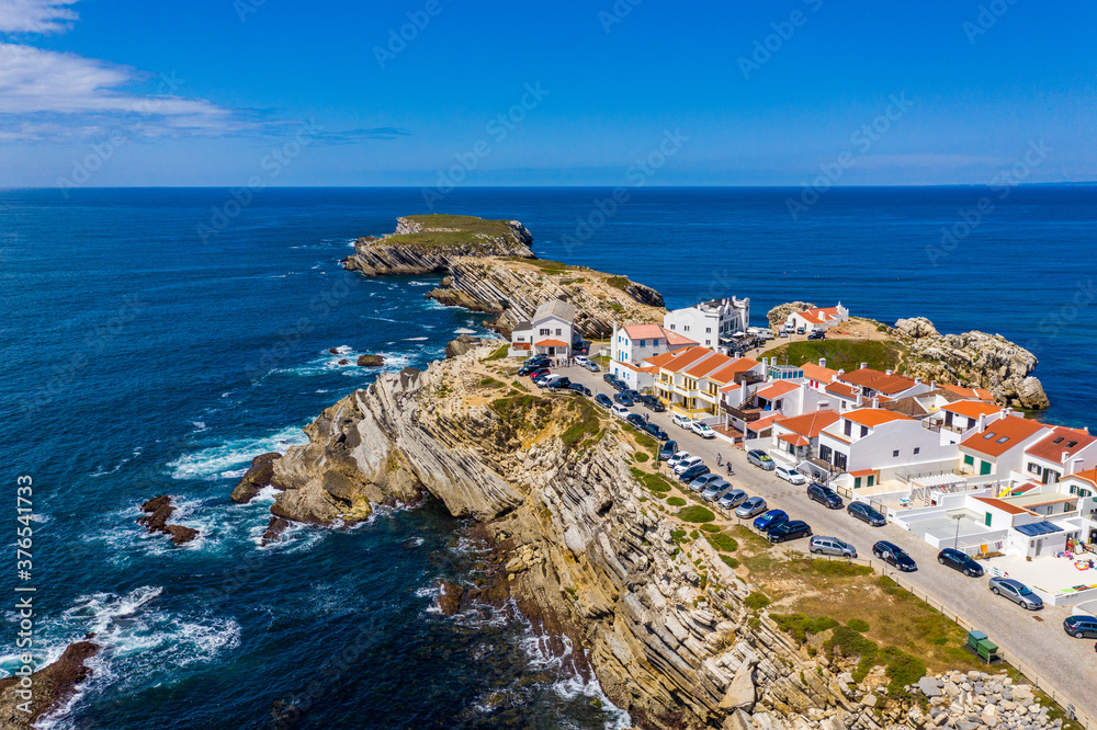 Aerial view of island Baleal naer Peniche on the shore of the ocean in west coast of Portugal. Baleal Portugal with incredible beach and surfers. Aerial view of Baleal, Portugal.