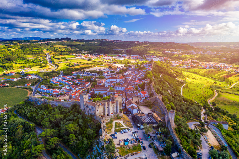 Aerial view of the historic walled town of Obidos at sunset, near Lisbon, Portugal. Aerial shot of Obidos Medieval Town, Portugal. Aerial view of medieval fortress in Obidos. Portugal.