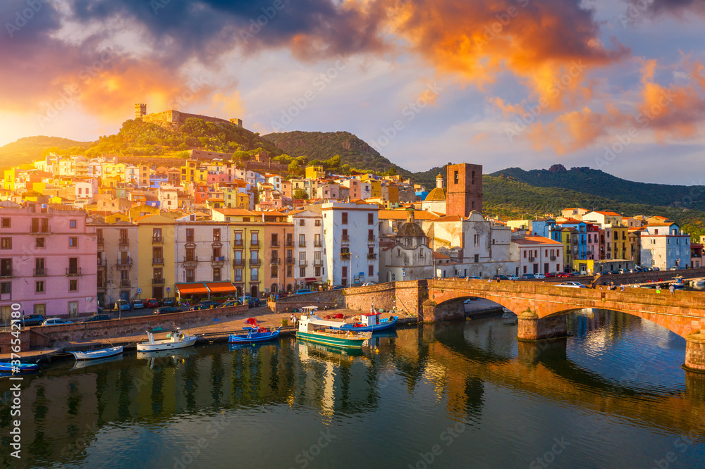Aerial view of the beautiful village of Bosa with colored houses and a medieval castle. Bosa is located in the north-wesh of Sardinia, Italy. Aerial view of colorful houses in Bosa village, Sardegna.