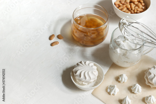 Cup with whipped aquafaba, for making marshmallows and meringues. jar with aquafaba and white beans, on a white background photo