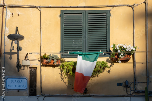 Italian Window with Wooden Shutters in a plastered wall © Tjeerd