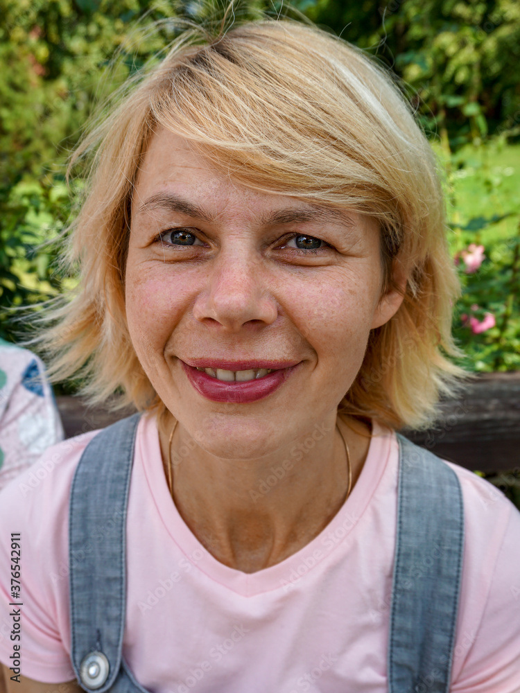 A cheerful Mature woman smiled at the photographer.