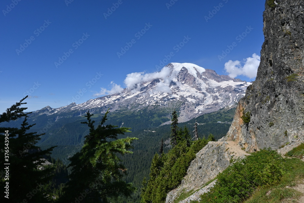 Mountain hiking trails and view of Mt Rainer with sky and clouds