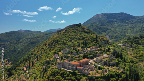 Aerial drone photo of medieval byzantine old city of Mystras featuring Monastery of Pantanassa, Temple of Agia Sofia and uphill castle of Mystras, Sparta, Peloponnese, Greece photo