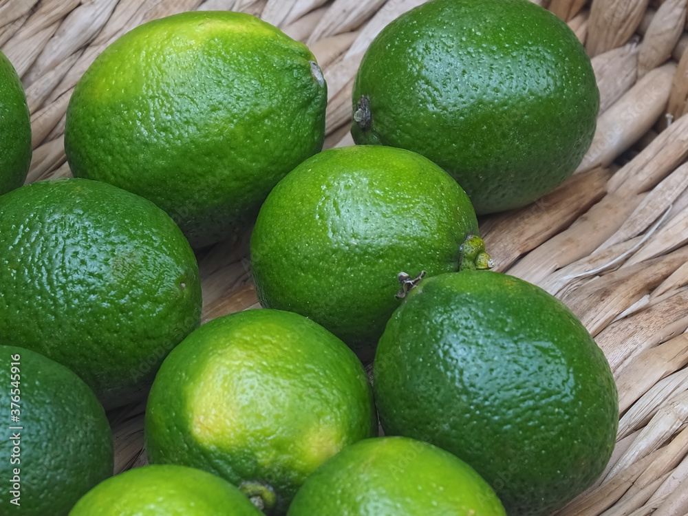 Sweet green limes in a basket on a food market Sweet green limes in a basket on a food market