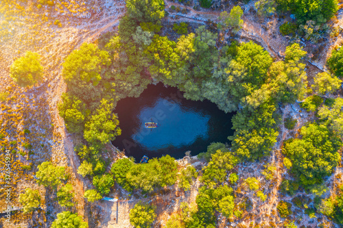 Famous Melissani lake on Kefalonia island, Karavomylos, Greece. On top of Melissani Cave (Melissani Lake) in Karavomylos village in Kefalonia island , Greece. Melissani Cave viewed from above.