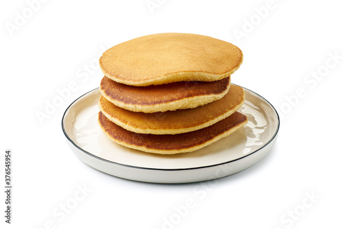 Dish with stacked pancakes on white