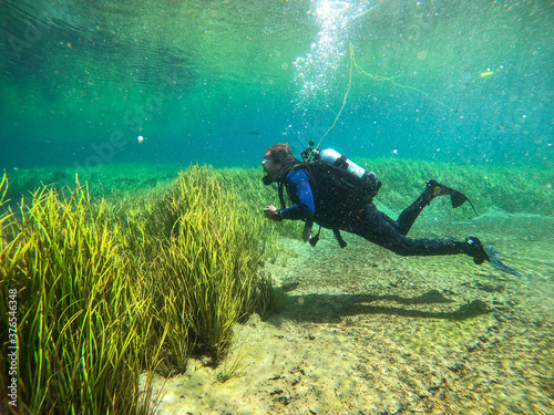 A senior man scuba diving in Rainbow River in Dunnellon, Florida photo
