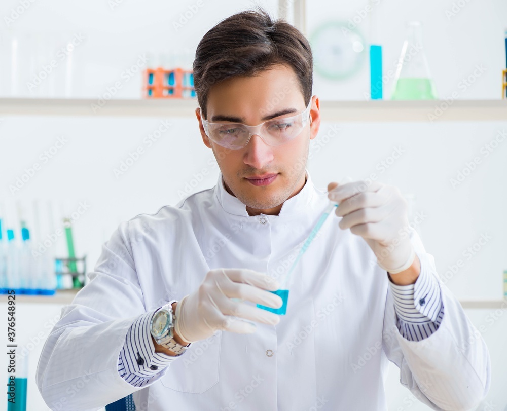 Young chemist student working in lab on chemicals Young chemist student working in lab on chemicals