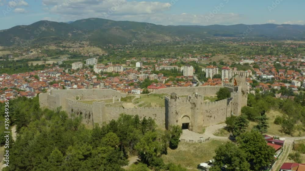 Aerial shot Ohrid Macedonia. Drone video of a fortress with towers standing on a mountain surrounded by a city with houses with red roofs and a beautiful landscape. Aerial shot Ohrid Macedonia. Drone video of a fortress with towers standing on a mountain surrounded by a city with houses with red roofs and a beautiful landscape.