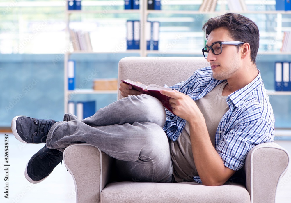 Student reading books and preparing for exams in library Student reading books and preparing for exams in library