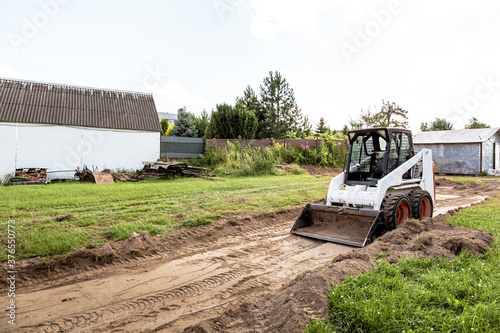 Canvas-taulu A skid steer loader clears the site for construction