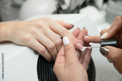 Woman getting nail manicure.