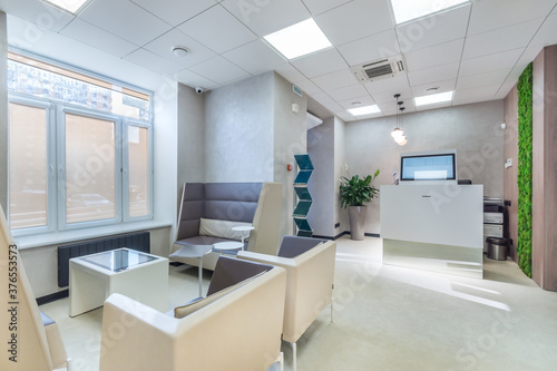 Fototapeta Naklejka Na Ścianę i Meble -  Inside the modern office: a stylish waiting area and high-tech reception counter