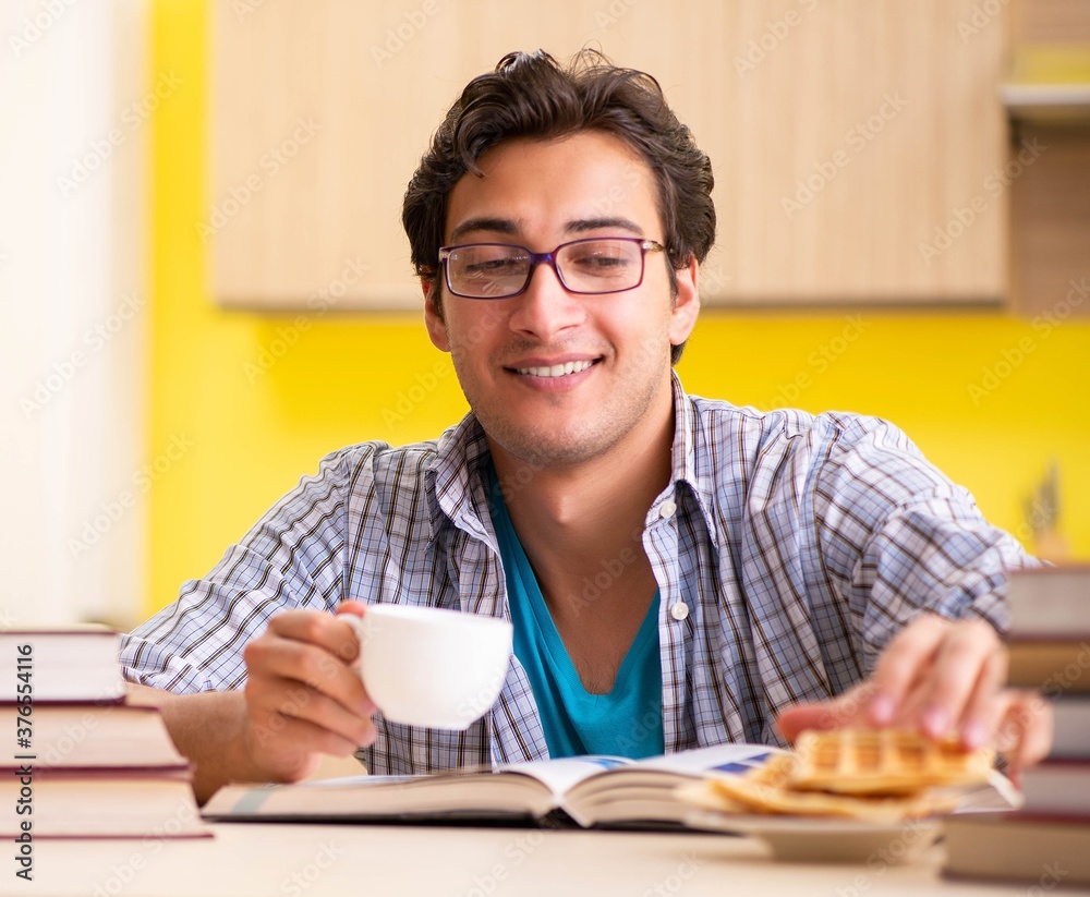 Student preparing for exam sitting at the kitchen Student preparing for exam sitting at the kitchen