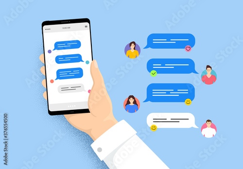 Hand holding phone with online messages. Smartphone with friends chatting. User characters of people. Speech bubbles on cellphone screen. Phone online messages. Friends conversation vector photo