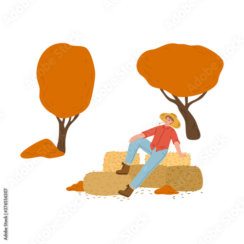 Man relaxing on haystacks during harvesting in autumn on countryside