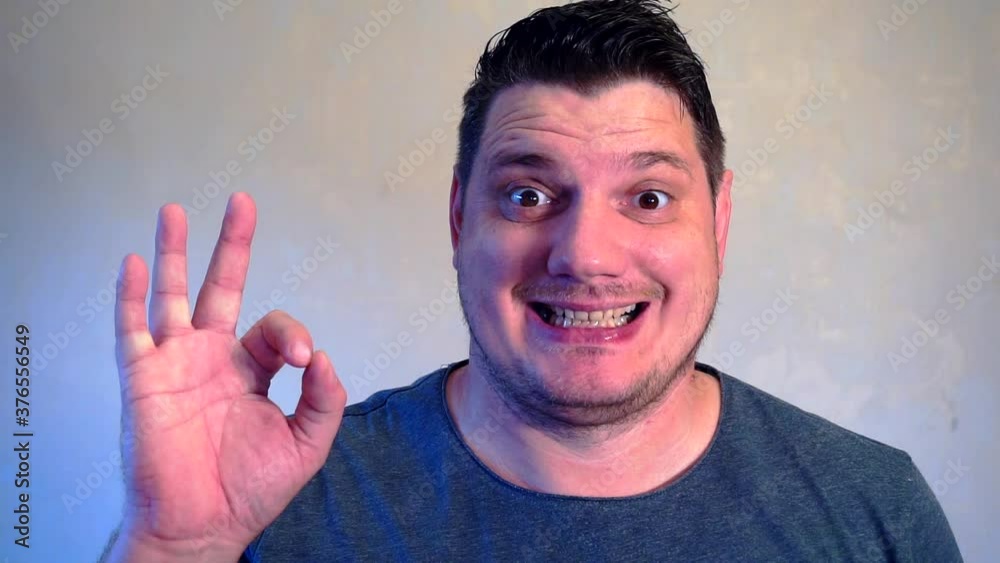 positive smiling man showing okay sign and smiling.closeup. positive smiling man showing okay sign and smiling.closeup.