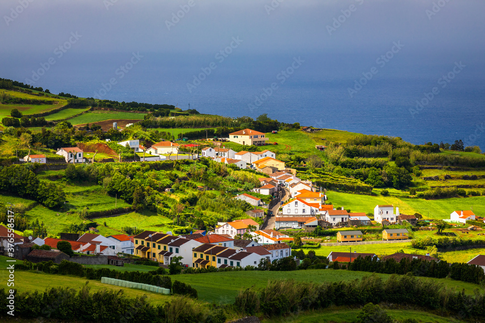 View of Pedreira village at northeast coast of Sao Miguel island, Azores, Portugal. View of Pedreira village and Pico do Bartolomeu at northeast coast of Sao Miguel island, Azores, Portugal.