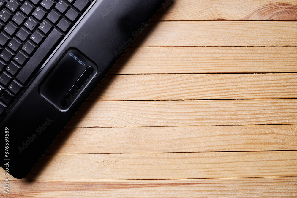 wooden rustic desk with black laptop on it. home workplace desktop. above view or flat lay. background backdrop wooden rustic desk with black laptop on it. home workplace desktop. above view or flat lay. background backdrop
