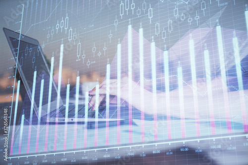 Double exposure of businesswoman hands typing on computer and forex chart hologram drawing. Financial analysis concept.