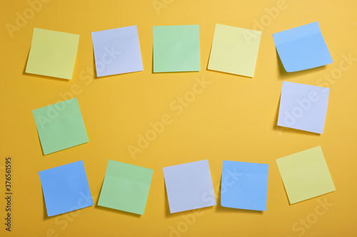 frame made of bright colored sticky notes on yellow background, copy space
