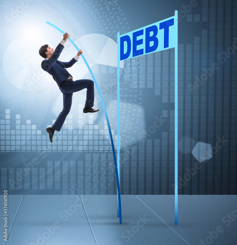 Businessman pole vaulting over debt in business concept © Elnur