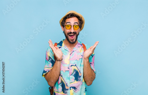 young bearded tourist man feeling shocked and excited, laughing, amazed and happy because of an unexpected surprise #376562187