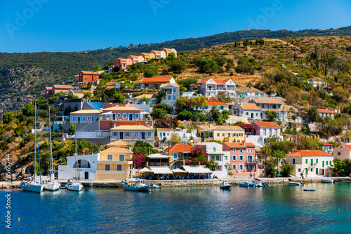 Turquoise colored bay in Mediterranean sea with beautiful colorful houses in Assos village in Kefalonia  Greece. Town of Assos with colorful houses on the mediterranean sea  Greece.