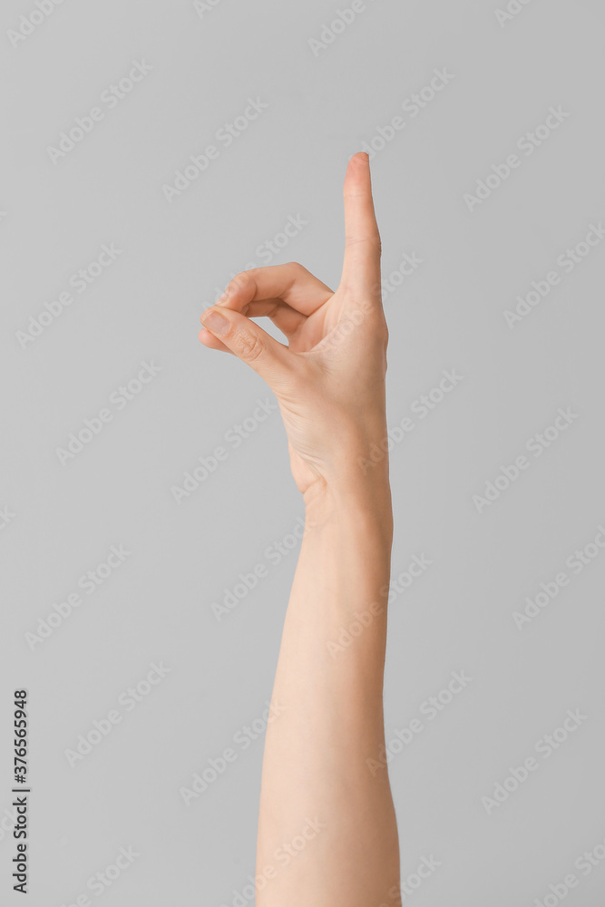 Hand showing letter D on grey background. Sign language alphabet Hand showing letter D on grey background. Sign language alphabet