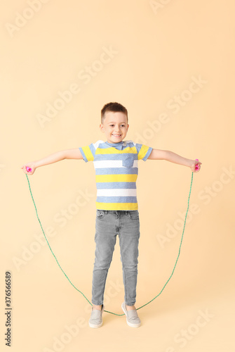 Cute little boy jumping rop...
