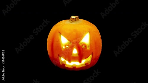Pumpkin jack o' lantern shining isolated on alpha channel, seamless looping. Halloween background, 4K 60 fps